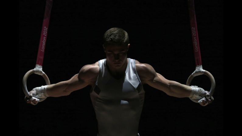 An athlete performs on the rings before the men's qualification for artistic gymnastics.