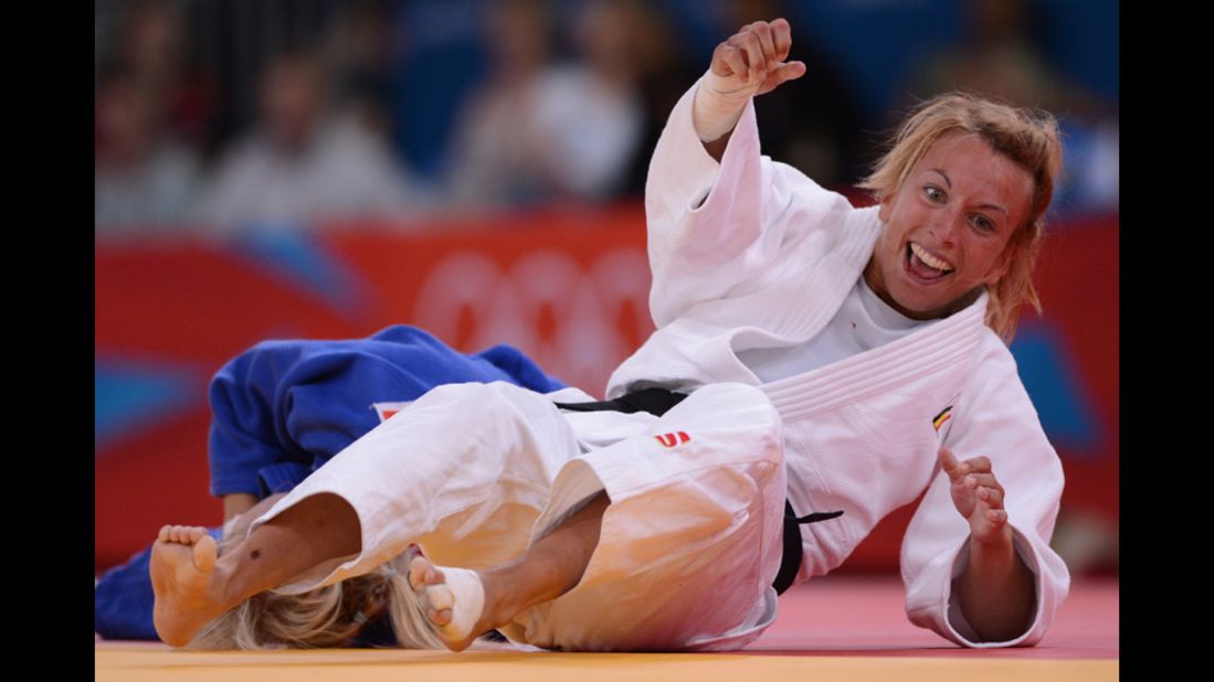 Belgium's Charline Van Snick, right, celebrates after winning against Hungary's Eva Csernoviczki during the women's judo match.
