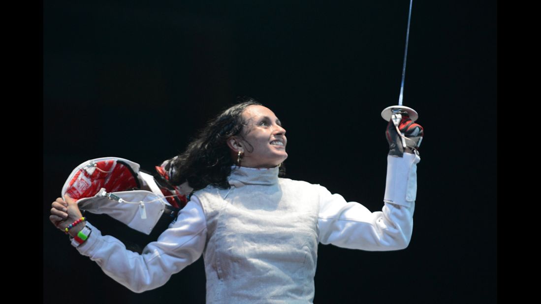 Tunisia's Ines Boubakri celebrates her victory over U.S. fencer Nicole Ross after their women's foil fencing bout.