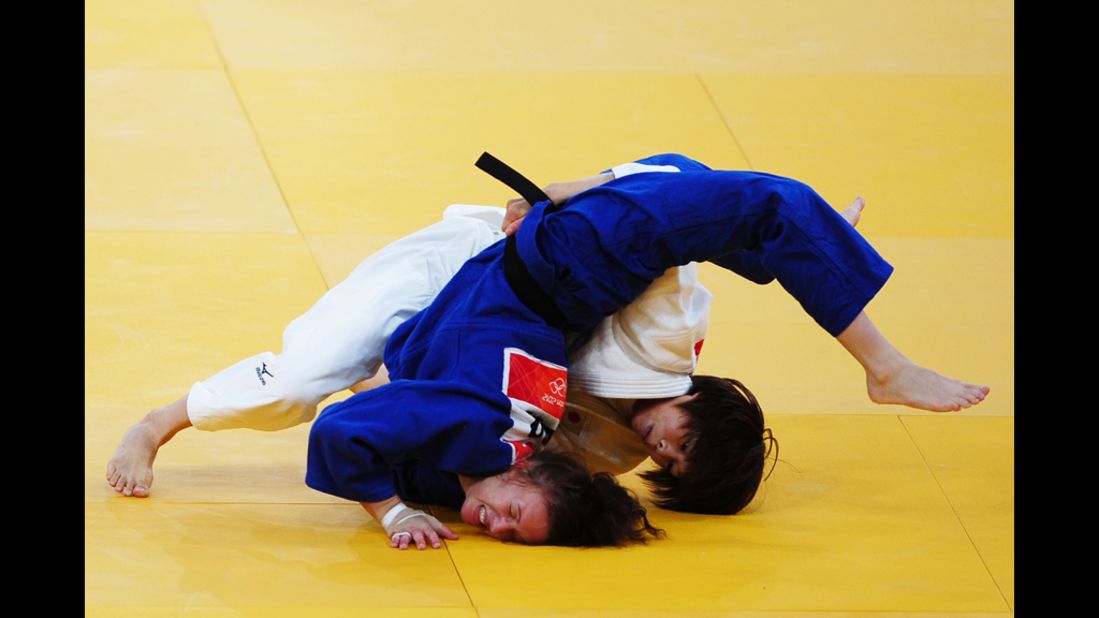 Tomoko Fukumi of Japan, in white, and Kelly Edwards of Great Britain compete in the women's judo competition.