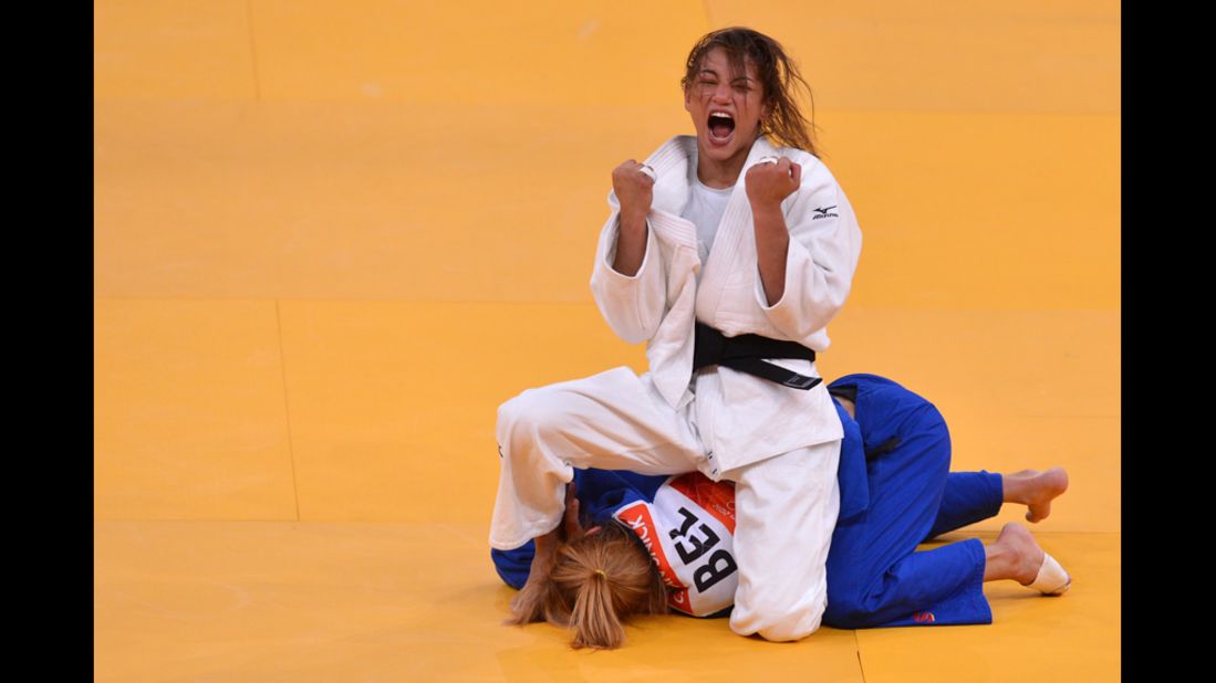 Brazil's Sarah Menezes (top) celebrates after beating Belgium's Charline Van Snick in the semi-final judo match.