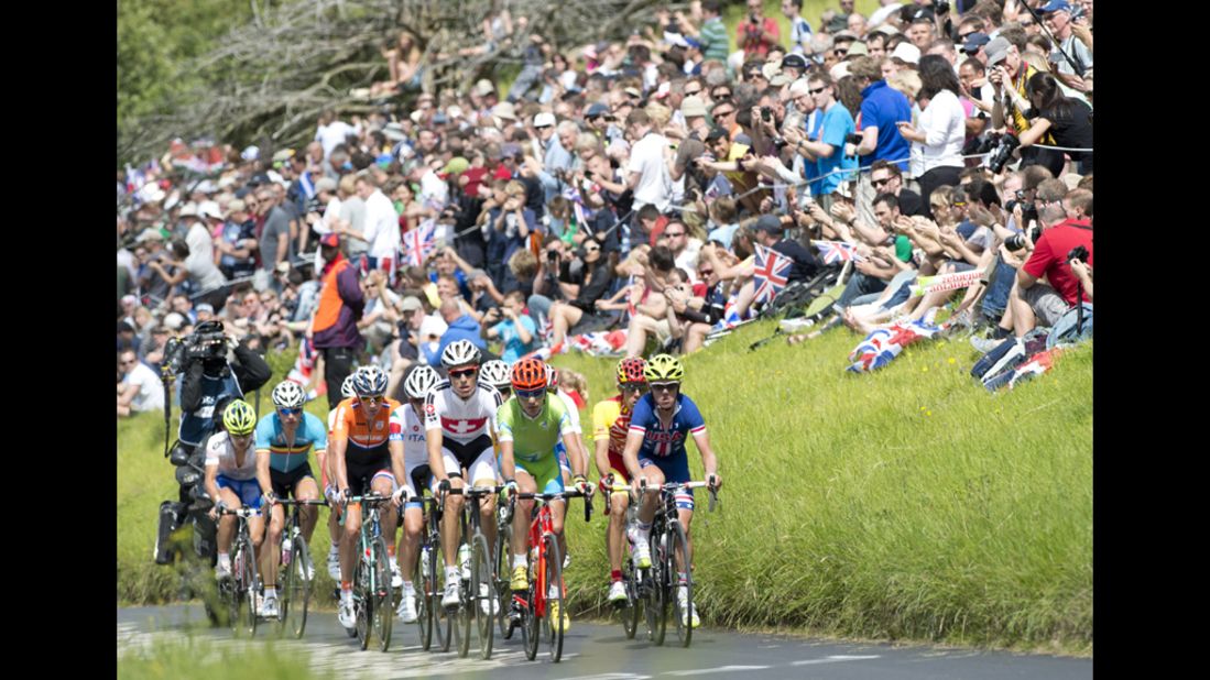 Spectators applaud as the peleton rides up Boxhill on the outskirts of London during the men's cycling road race.