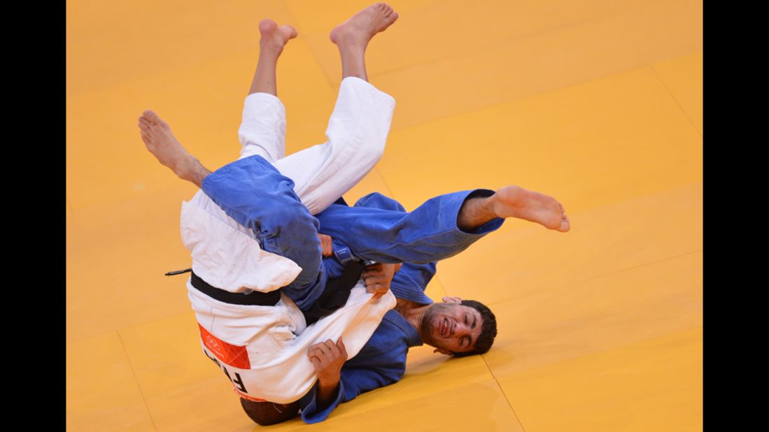 France's Sofiane Milous, left, competes with Armenia's Hovhannes Davtyan during their men's judo match.