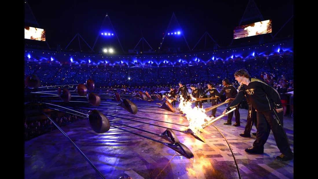 The Olympic flame is lit inside the stadium.
