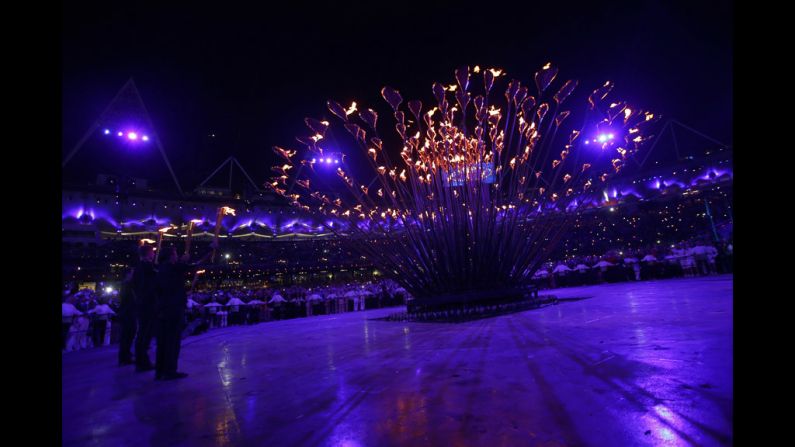 The athletes ignited an outer rim of torches, setting off a chain reaction, spreading fire to other pieces until the cauldron was engulfed.