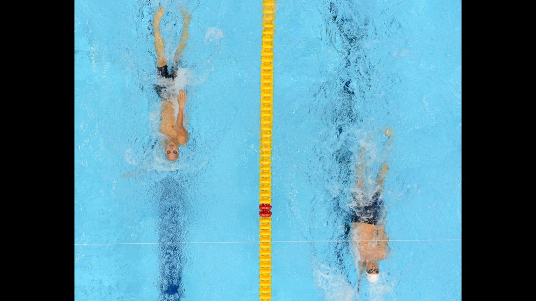 U.S. swimmer Michael Phelps, right, and Hungary's Laszlo Cseh compete in the men's 400 meter individual medley heats.
