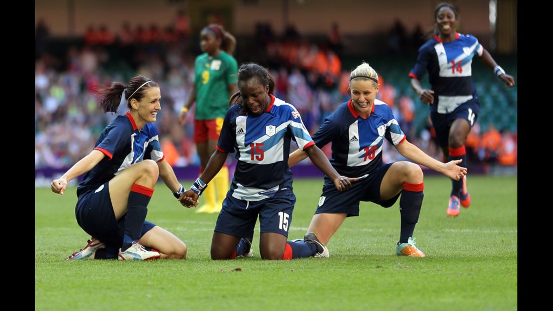Jill Scott, left, of Great Britain celebrates scoring with teammates Eniola Aluku and Kelly Smith during a first-round women's soccer game against Camaroon. 