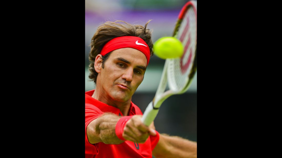 Switzerland's Roger Federer returns the ball to Colombia's Alejandro Falla during the men's singles tennis match.