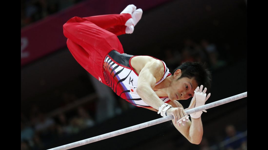 Japanese gymnast Kazuhito Tanaka competes on the horizontal bar during the men's artistic gymnastics qualification event.