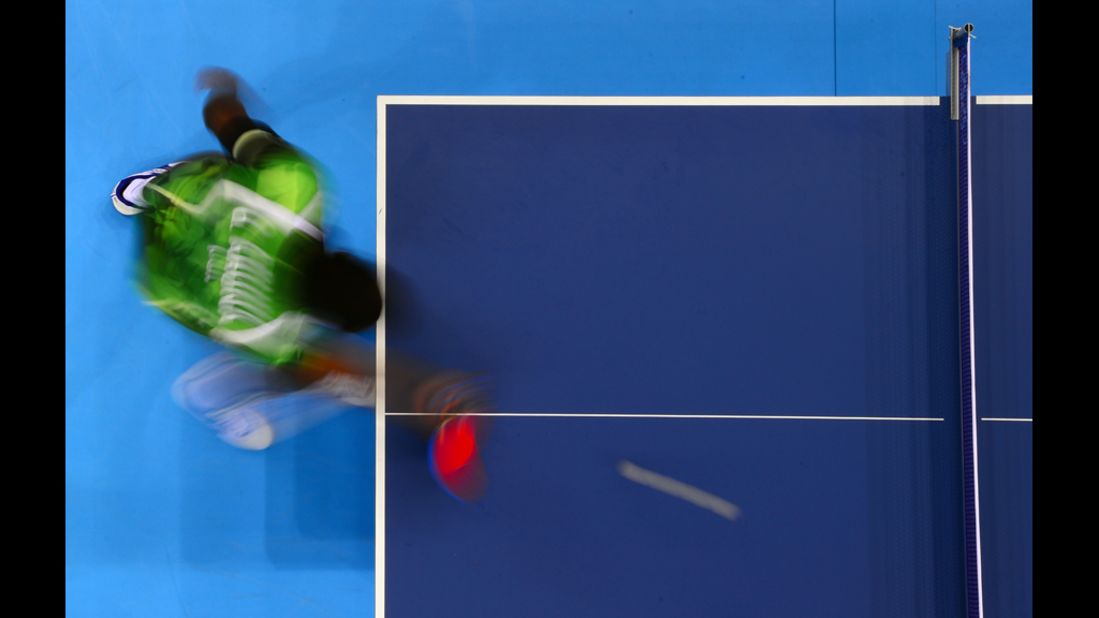 A picture taken with a robotic camera shows Nigeria's Quadri Aruna returning to Spain's Carlos Machado during their first round men's table tennis match.