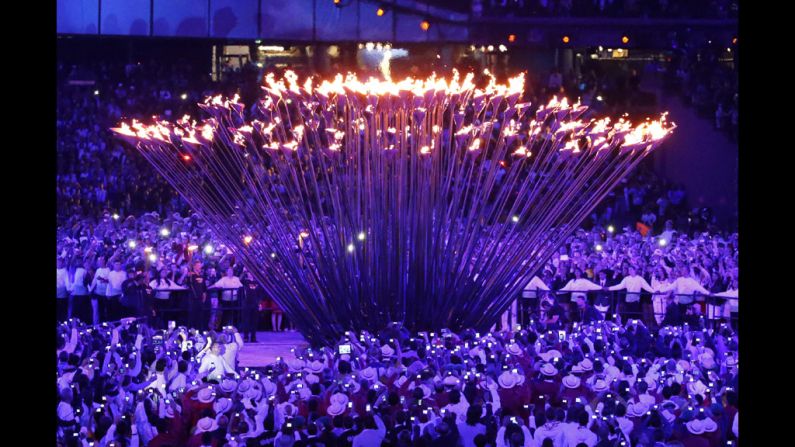 The individual torches rise up to form and engulf the cauldron in fire. 