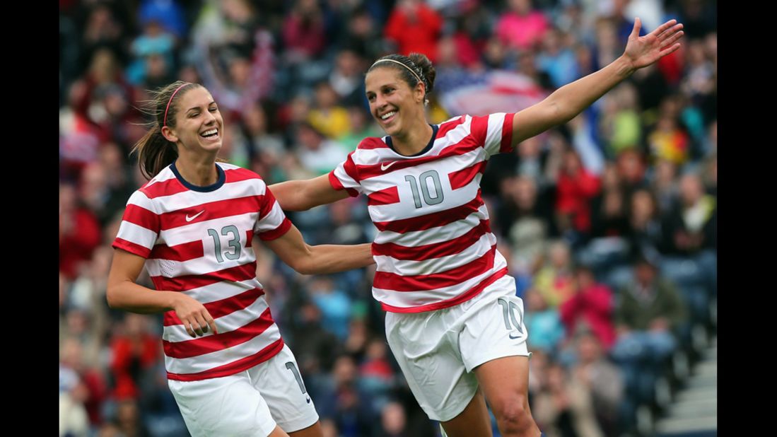 U.S soccer player Carli Lloyd, No.10, and teammate Alex Morgan, No.13, celebrate after scoring their third goal during a first-round game against Colombia.