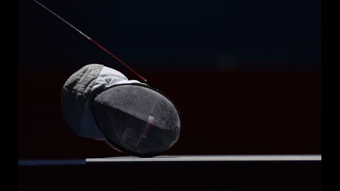 A fencing helmet lies on the field during an interruption of the women's foil fencing semifinal bout between Italy's Arianna Errigo and Italy's Valentina Vezzali.