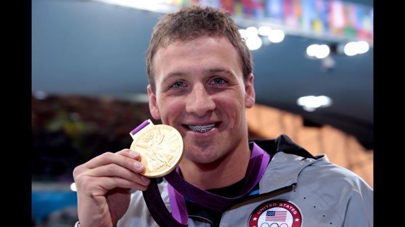 Ryan Lochte celebrates with his gold medal during the men's 400-meter individual medley medal ceremony on Saturday. He captured the first U.S. gold medal of the Games.