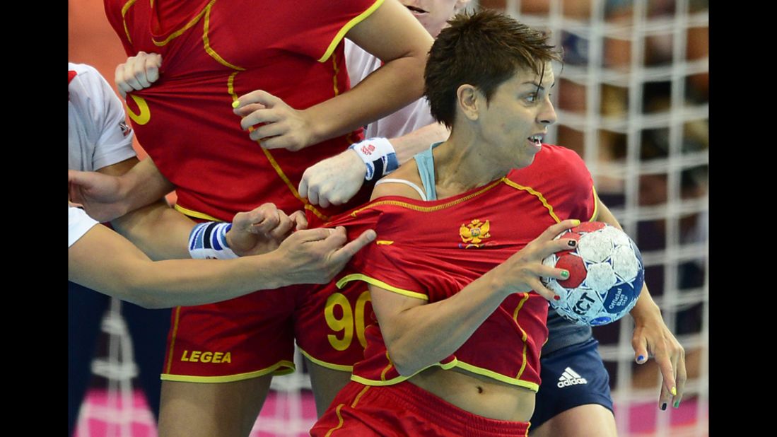 Montenegro's pivot Ana Dokic vies with her competitors from Great Britain during a women's handball preliminary match. 