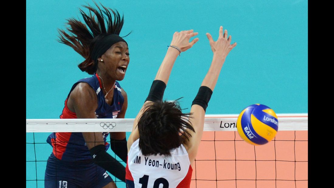 U.S. volleyball player Destinee Hooker, left, spikes as South Korea's Kim Yeon-Koung attempts to block in the women's volleyball match.