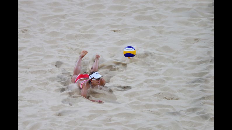 Nadine Zumkehr of Switzerland dives for the ball against Greece during the women's beach volleyball preliminaries.