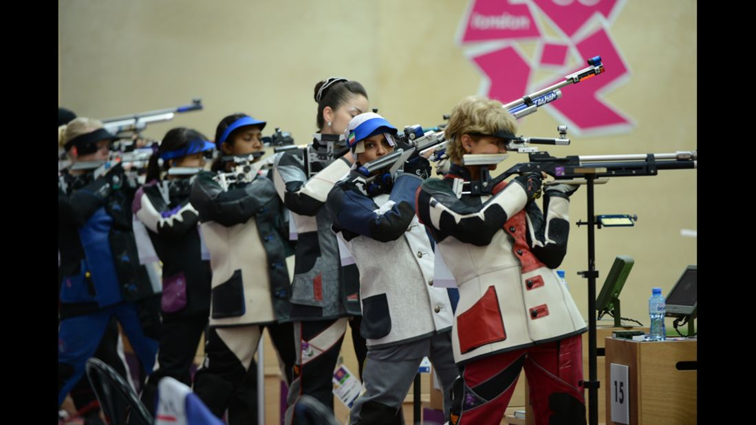 Iran's Elaheh Ahmadi, second from right, competes during the women's 10-meter air rifle qualification at the Royal Artillery Barracks.