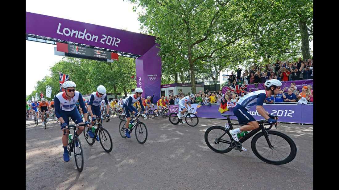 Mark Cavendish of Britain, right, takes off at the start of men's road race cycle event.