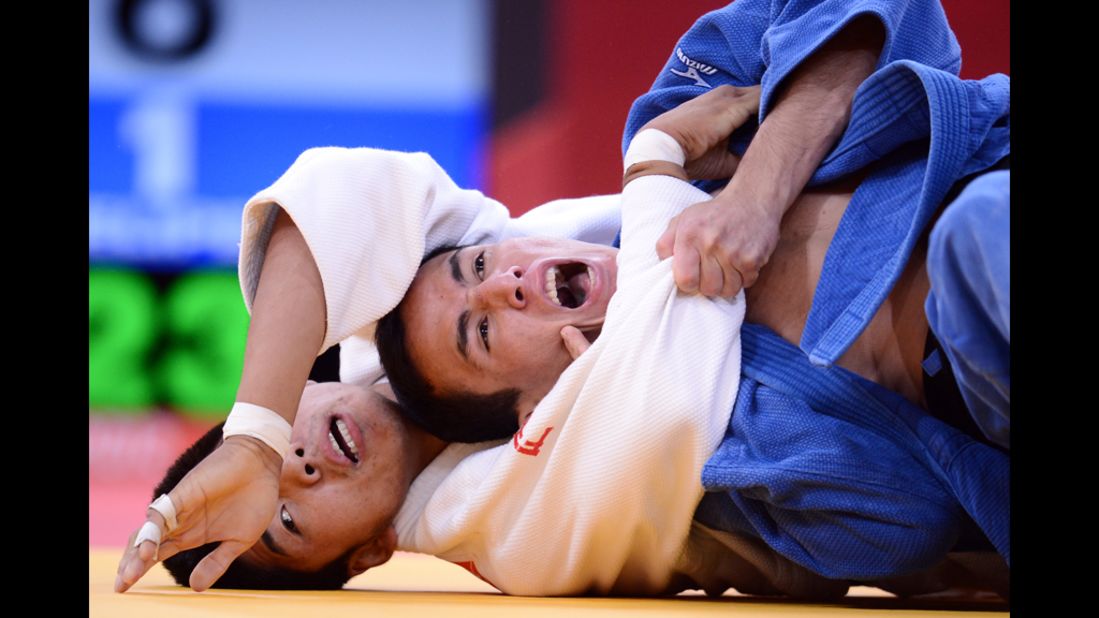 Mongolia's Tumurkhuleg Davaadorj, left, competes with Brazil's Felipe Kitadai during a judo match.