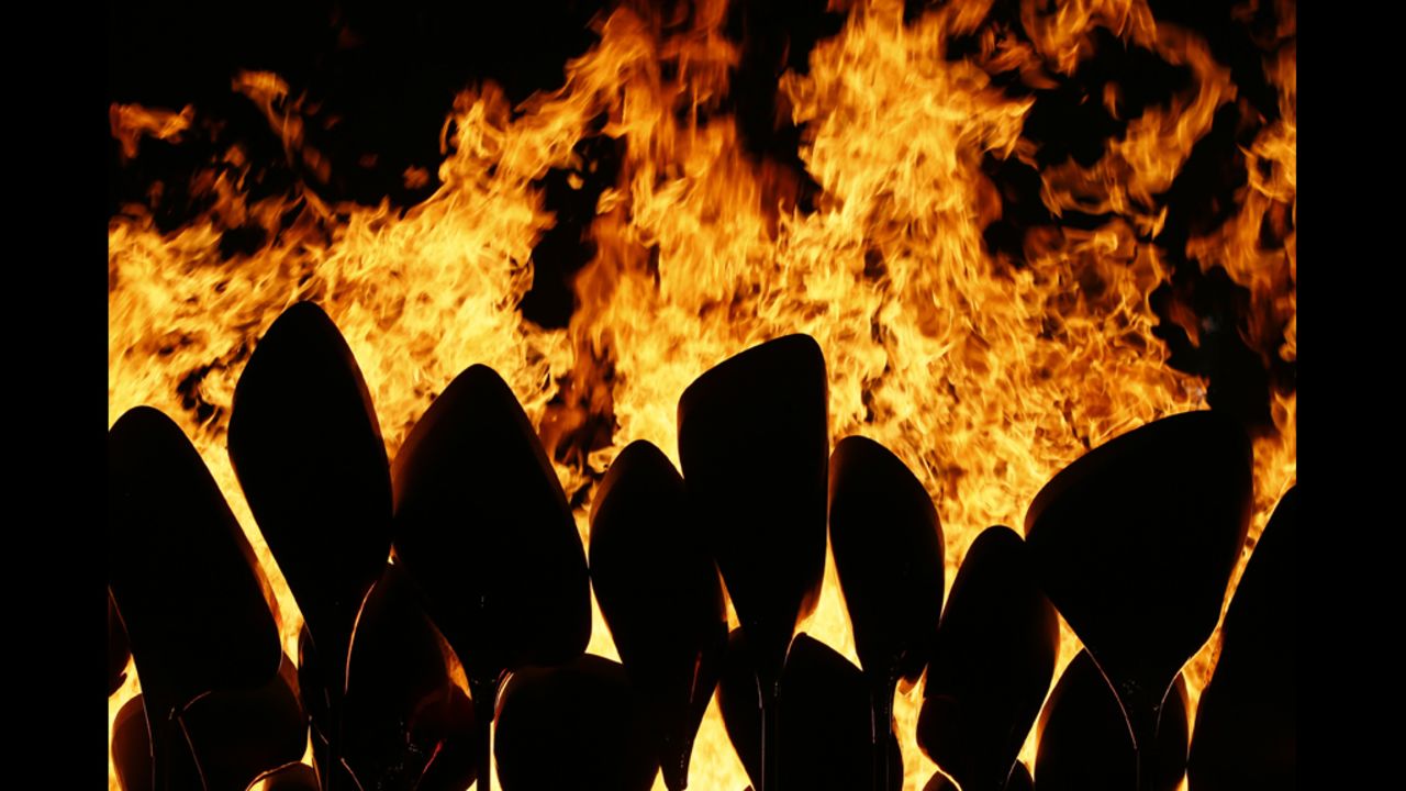 The Olympic flame is seen in the stadium during the ceremony.