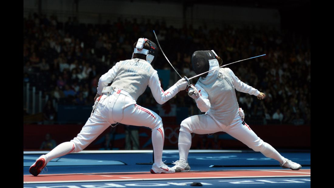 Japan's Nishioka Shiho, left, fences against Hong Kong's Lin Po Heung during their women's foil bout.