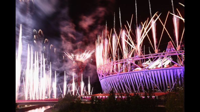 Fireworks cast a purple glow over the Olympic Stadium.