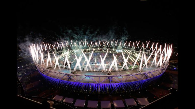 Fireworks ignite over the Olympic Stadium.