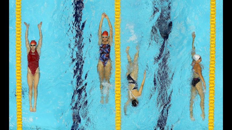 Swimmers warm up with laps prior to competition.