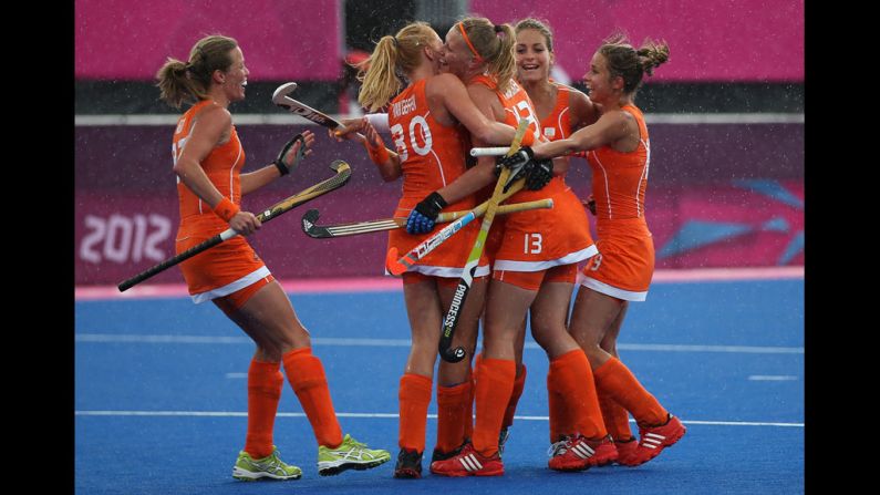 The Netherlands' women's field hockey team celebrates a third goal against Belgium.