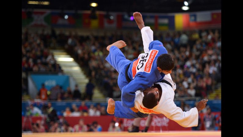 France's David Larose, in white, and Lasha Shavdatuashvili of Georgia, in blue, face off during the men's half lightweight judo event.