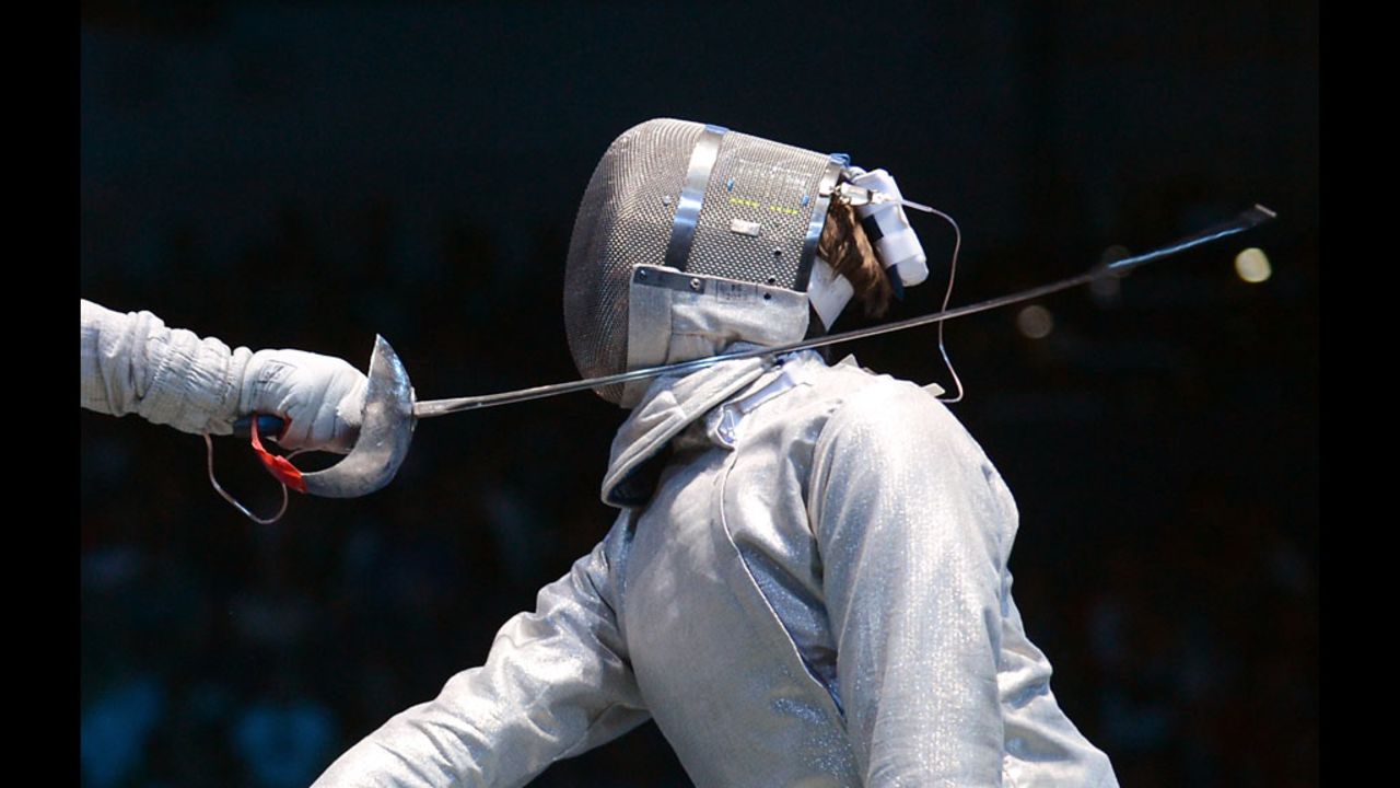 Dmitry Lapkes, right, of Belarus does battle with Canada's Philippe Beaudry in a fencing bout Sunday at London's ExCeL arena.