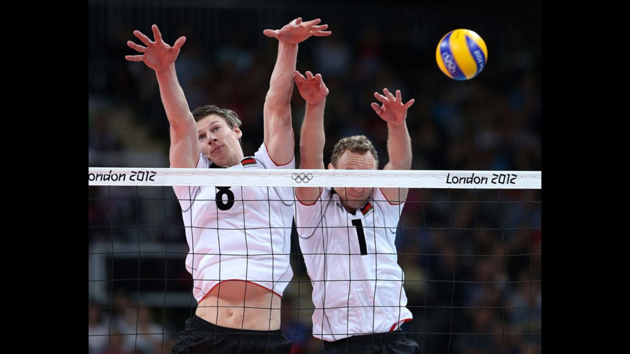 Germany's Marcus Bohme, left, and Marcus Popp attempt to block a shot from Russia during men's volleyball competition.