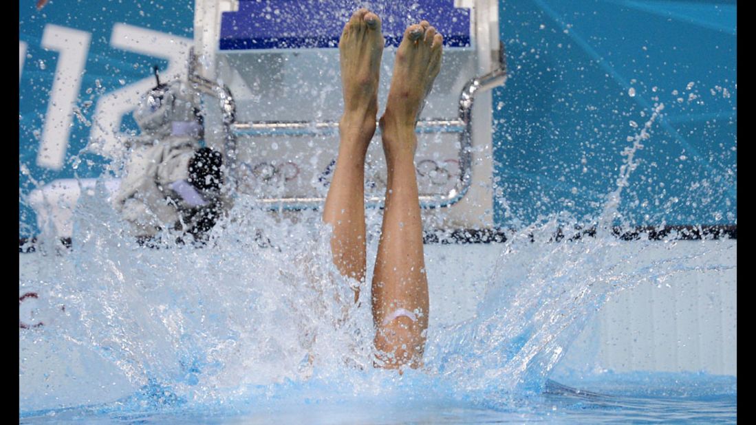 France's Camille Lacourt dives in the water before the men's 100-meter backstroke heat.