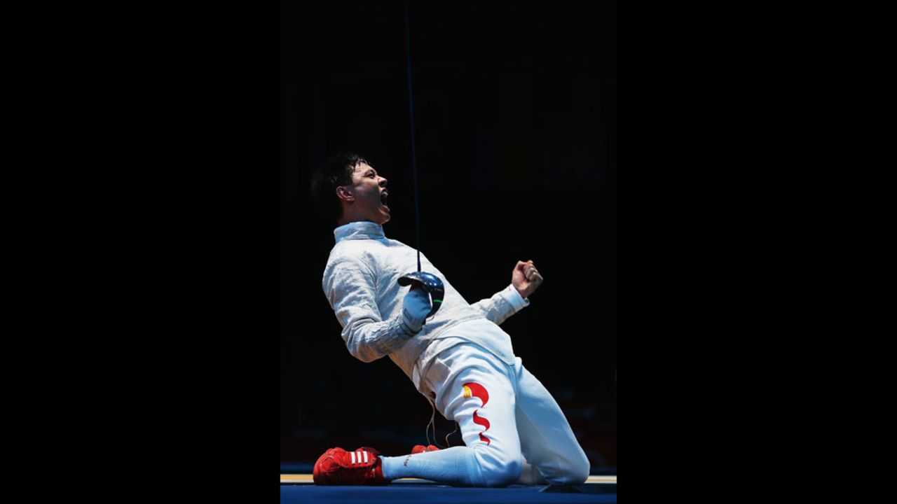 China's Man Zhong celebrates after winning the men's saber individual fencing round against South Korea's Junghwan Kim.
