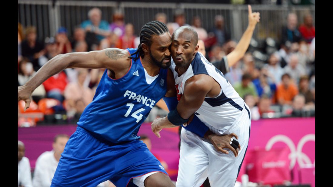 French center Ronny Turiaf challenges U.S. guard Kobe Bryant during the men's preliminary round Group A match.