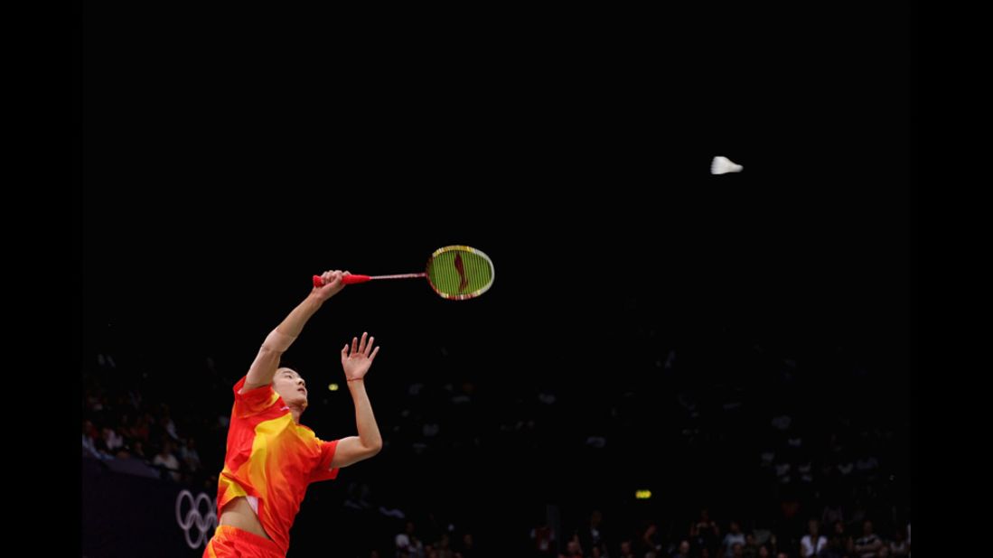 Long Chen of China returns a shot against Boonsak Ponsana of Thailand during the men's singles badminton match at Wembley Arena.