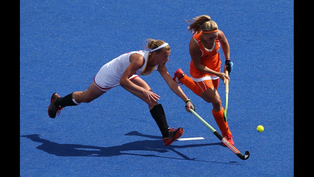 Belgium's Gaelle Valcke competes against the Kitty van Male of the Netherlands during a women's field hockey match.