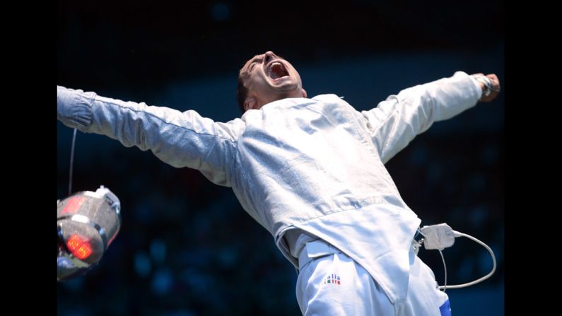 Italy's Diego Occhiuzzi celebrates his victory over Italian teammate Aldo Montano at the end of the men's saber fencing bout.