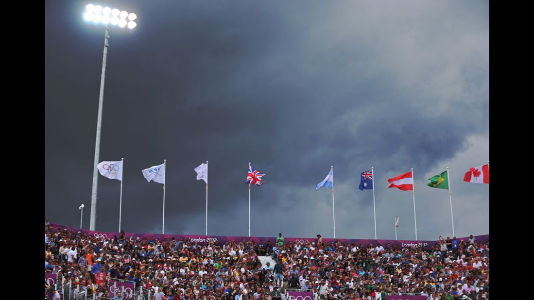 Dark skies loom during the men's beach volleyball preliminary match between Brazil and Austria at the Horse Guards Parade in London.