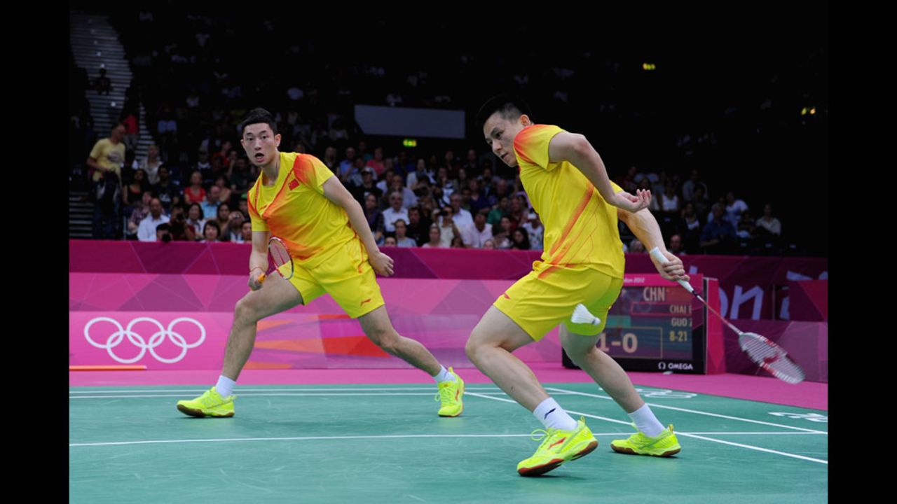 China's Biao Chai, right, and Zendong Guo return a shot against South African competitors during a men's doubles badminton match at Wembley Arena.