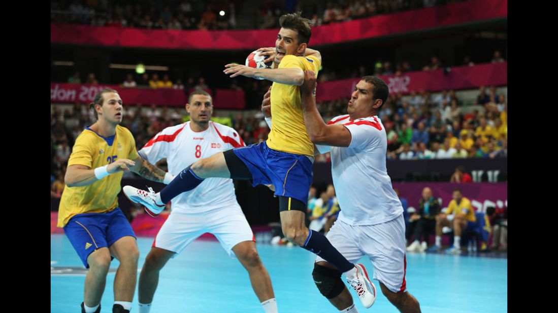 Sweden's Dalibor Doder jumps to shoot during a men's handball preliminary match between Sweden and Tunisia.