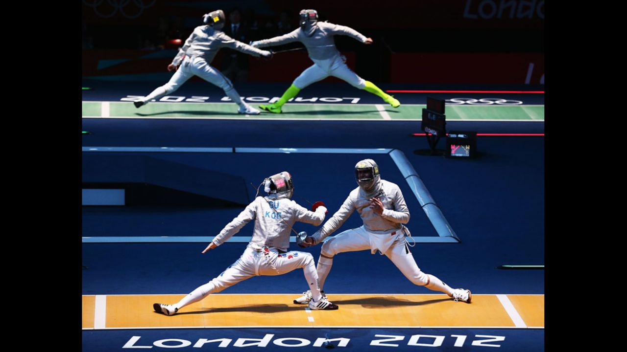 South Korea's Bongil Gu, left, and Max Hartung of Germany face off in the men's saber individual fencing round.