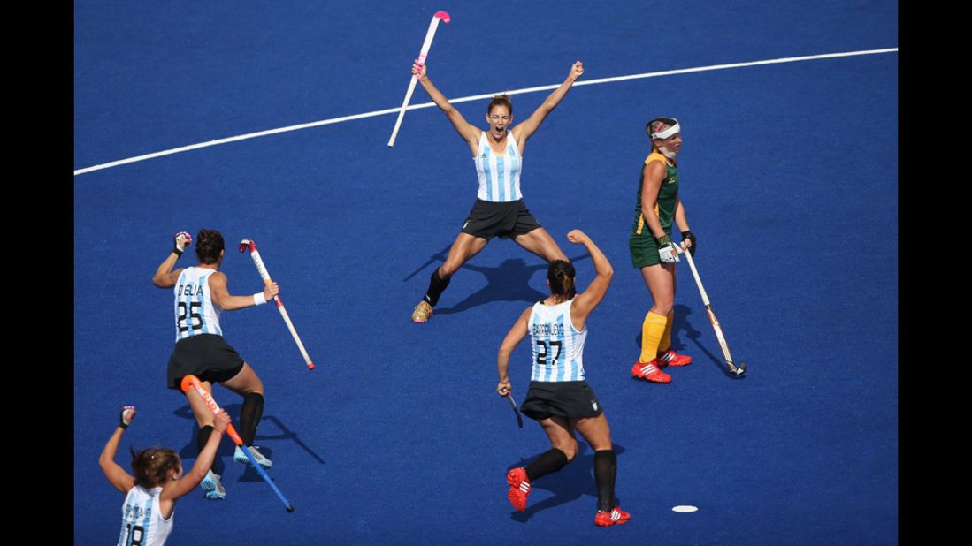 Argentina's Luciana Aymar, center, rear, and her teammates cheer after she scored the opening goal during a women's field hockey match between Argentina and South Africa 