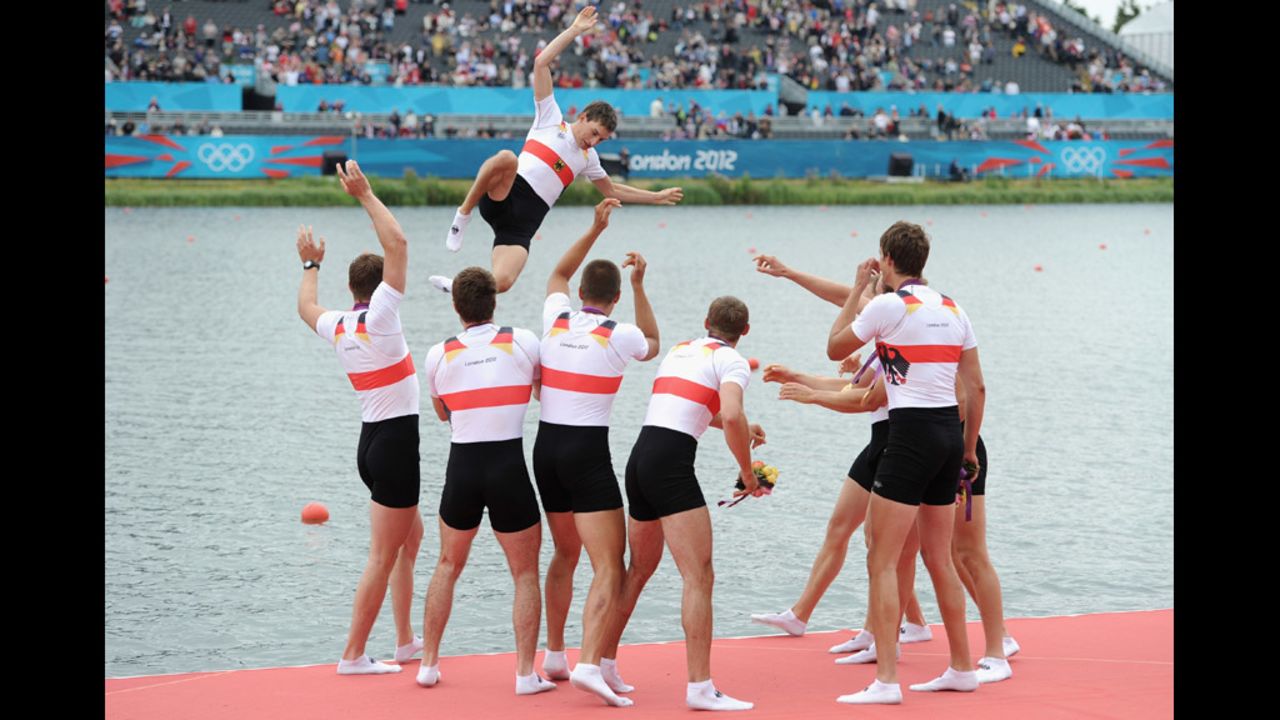 Germany's rowing team throws their cox, Martin Sauer, into the water after winning gold in the men's eight final.