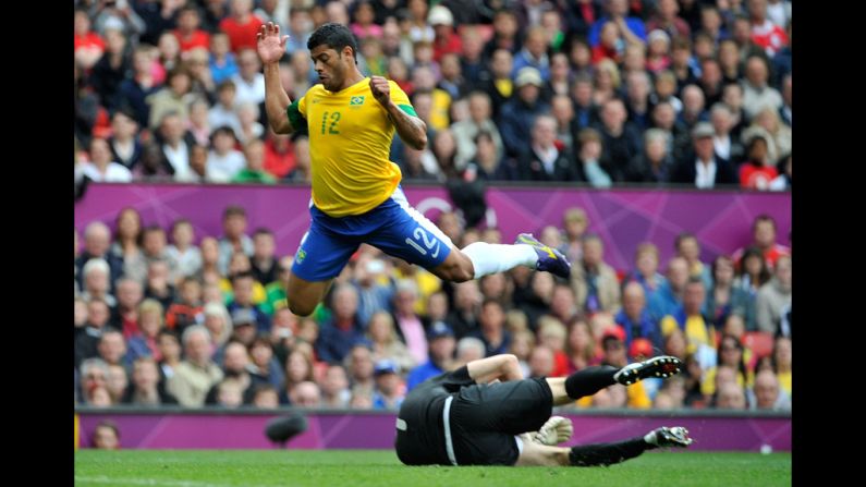 Brazil's Hulk leaps over Aleksandr Gutor of Belarus during a first-round group C football match in Manchester.