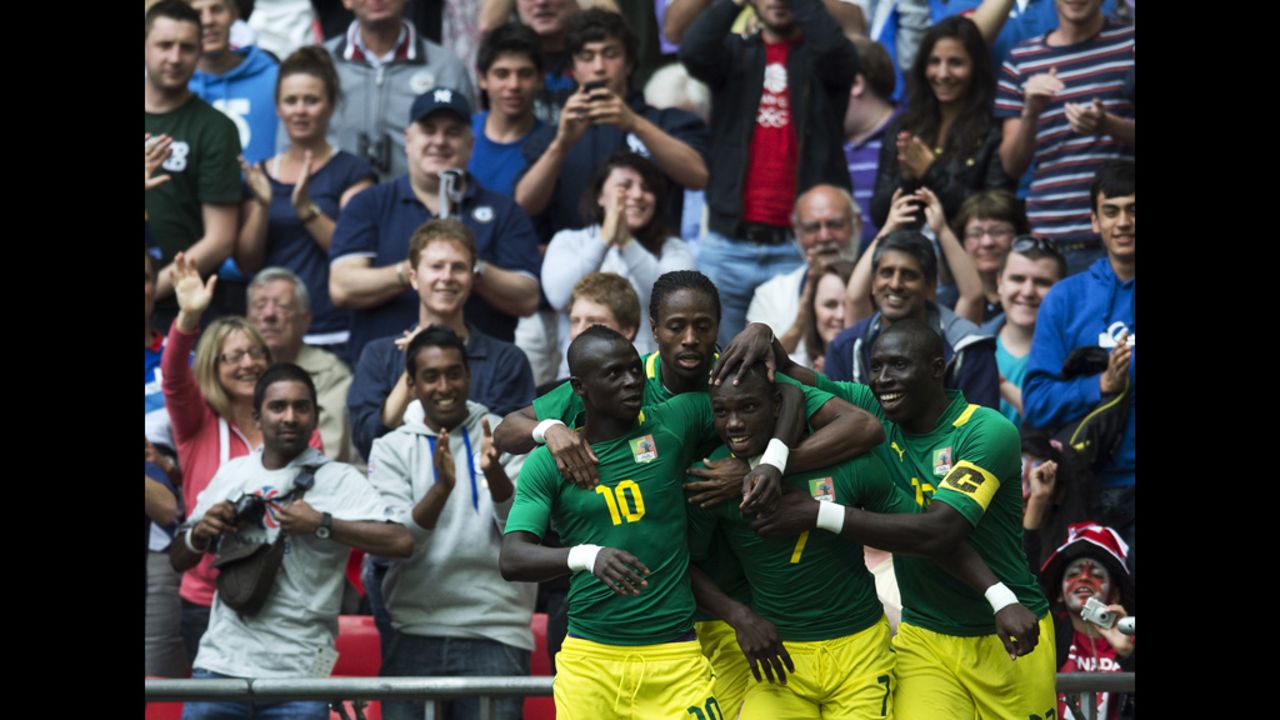 Teammates congratulate Senegal's Moussa Konate after he scores the opening goal against Uruguay in Wembley Stadium.