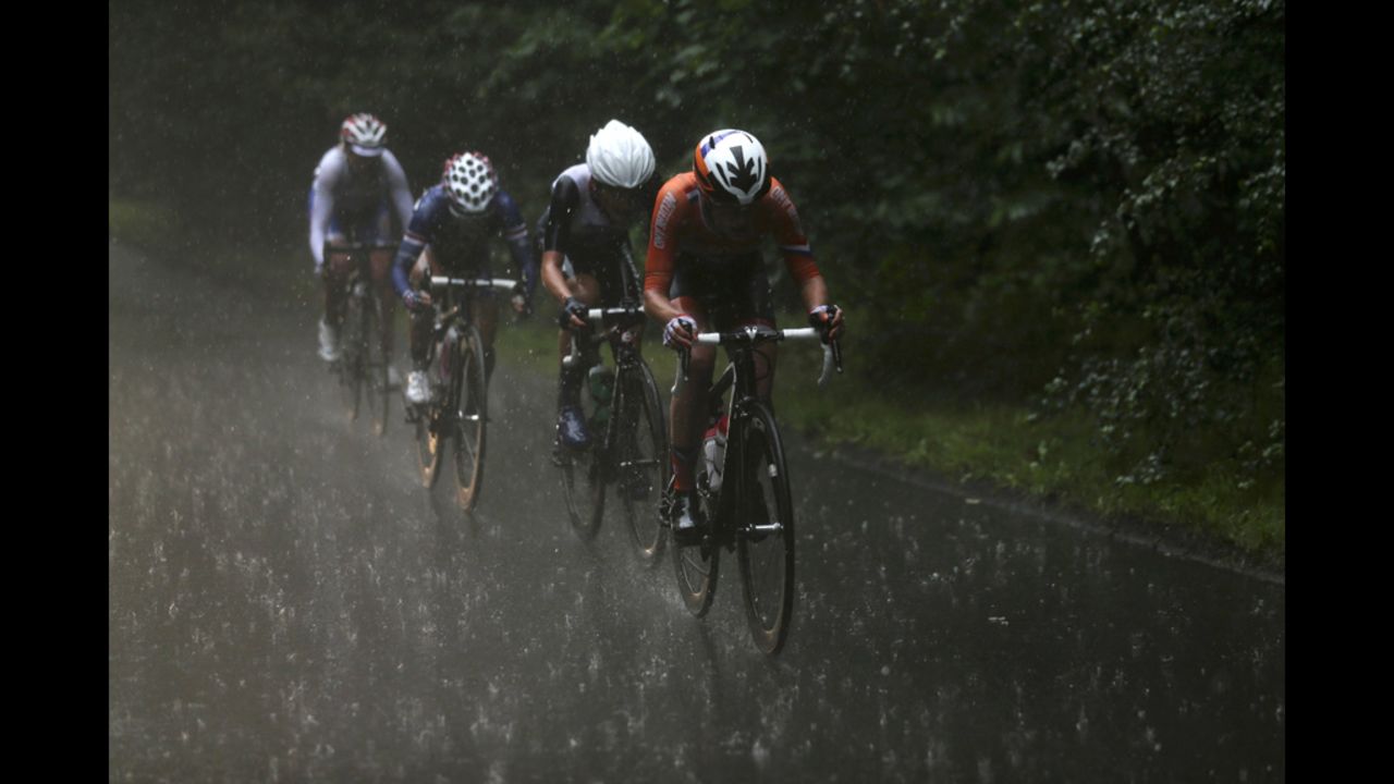 From right, Marianne Vos of the Netherlands, Elizabeth Armitstead of Great Britain, Kristin Armstrong of the United States and Olga Zabelinskaya of Russia cycle in a downpour during the women's road race.