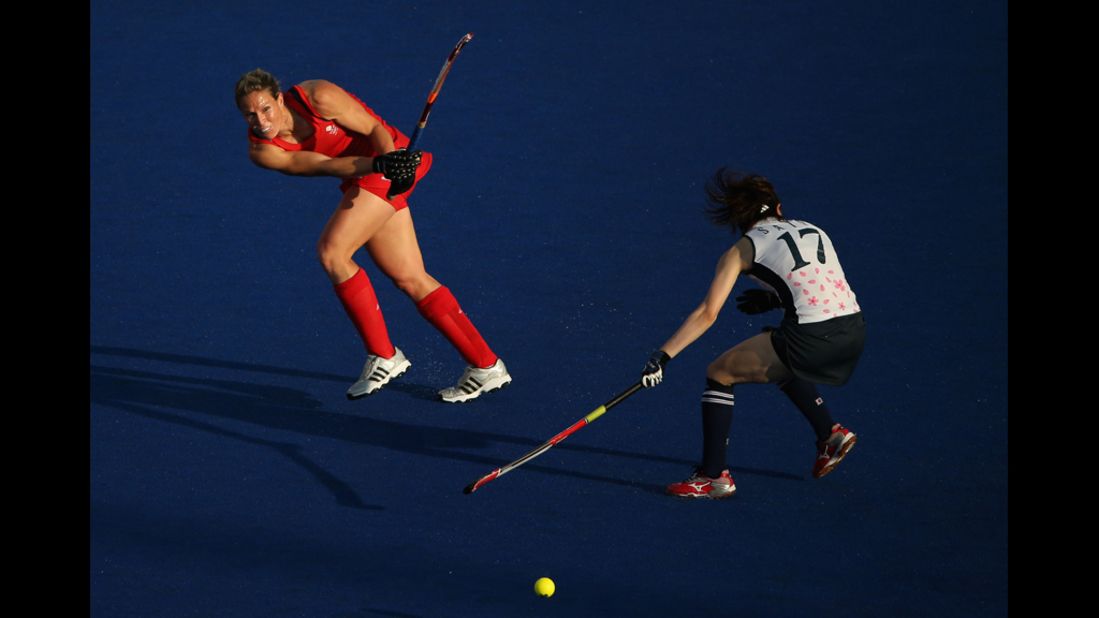 Crista Cullen of Great Britain competes against Masako Sato of Japan during a women's field hockey match.
