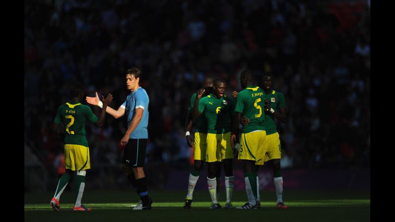 Senegalese players celebrate at the end of the football match against Uruguay in Wembley Stadium. Senegal defeated Uruguay 2-0.